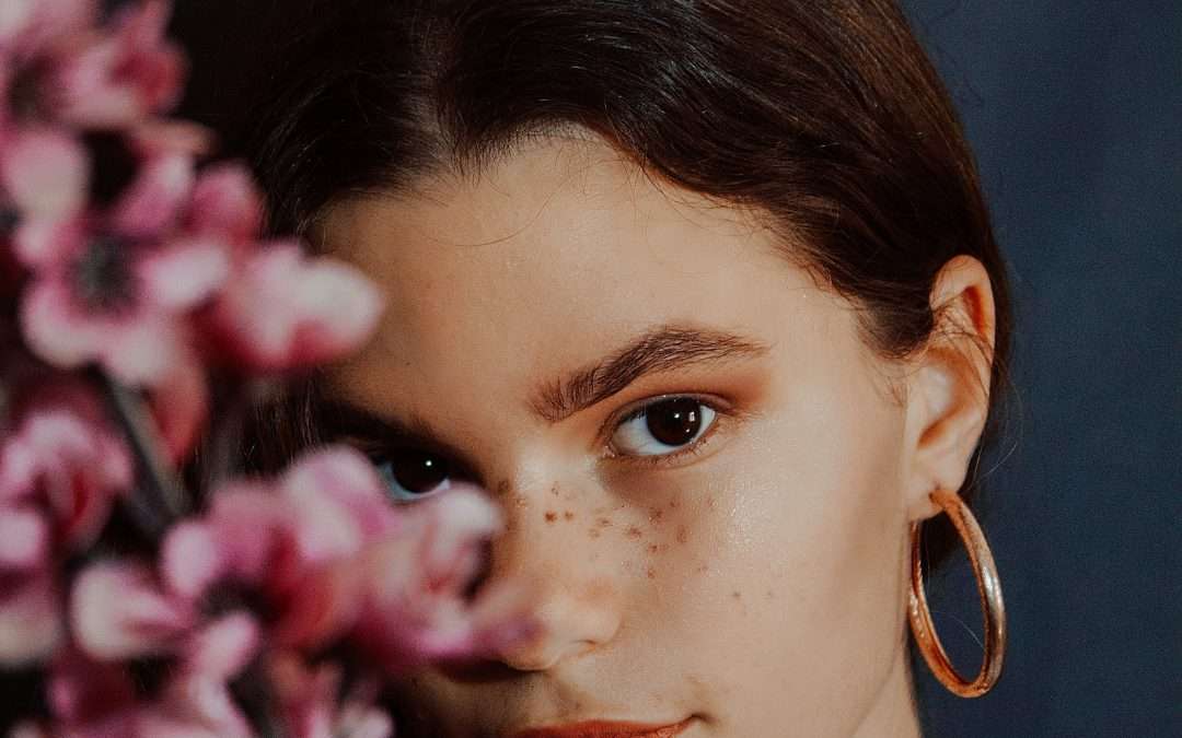 A woman hiding behind flowers